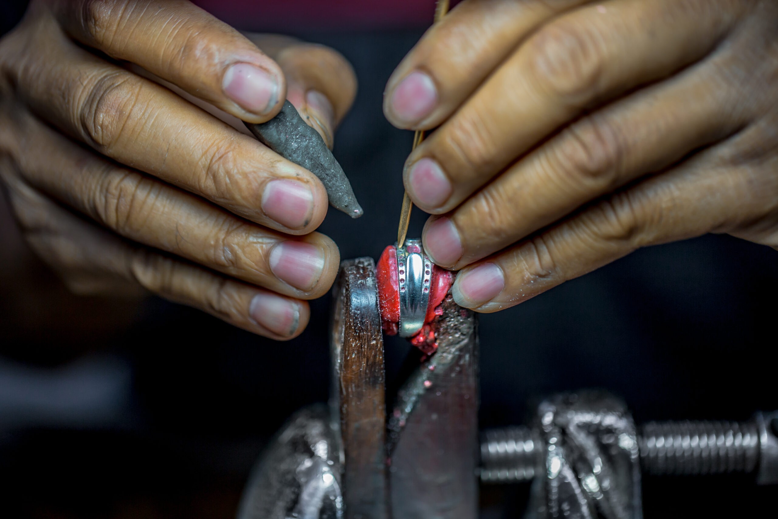 Thai jeweler, handles the jewelry and precious stones in the workshop, the process of jewelry making ,close-up